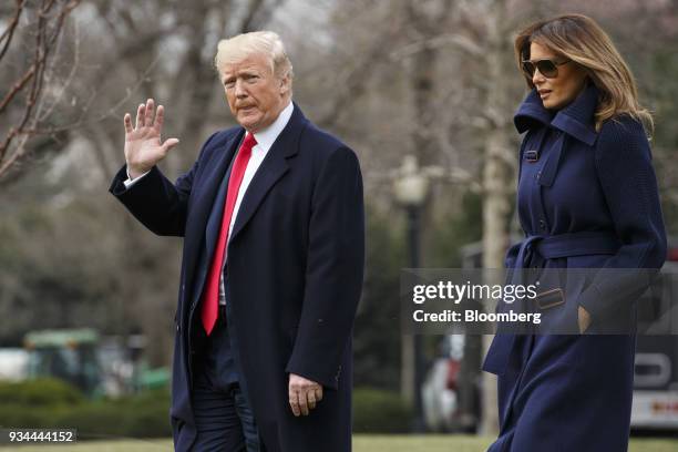 President Donald Trump waves while walking with First Lady Melania Trump, right, to board Marine One on the South Lawn of the White House in...