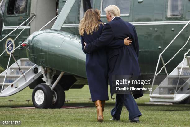 President Donald Trump and U.S. First Lady Melania Trump, left, walk towards Marine One on the South Lawn of the White House in Washington, D.C.,...