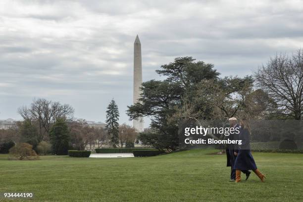 President Donald Trump and U.S. First Lady Melania Trump, right, walk towards Marine One on the South Lawn of the White House in Washington, D.C.,...