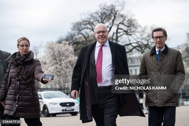 Newly named German Economy Minister Peter Altmaier arrives to speak to the press in front of the White House in Washington, DC, on March 19, 2018. /...