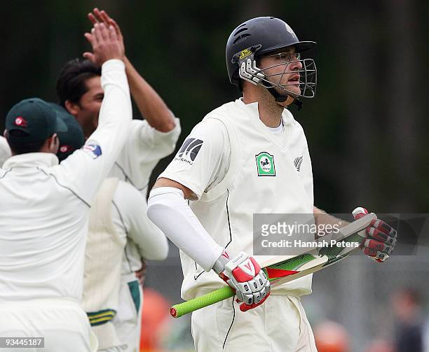 Daniel Vettori of New Zealand walks off after being dismissed by Mohammad Asif of Pakistan during day four of the First Test match between New...