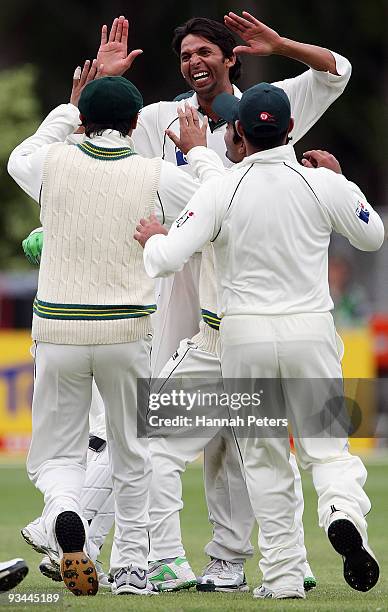 Mohammad Asif of Pakistan celebrates claiming the wicket of Daniel Vettori of New Zealand during day four of the First Test match between New Zealand...