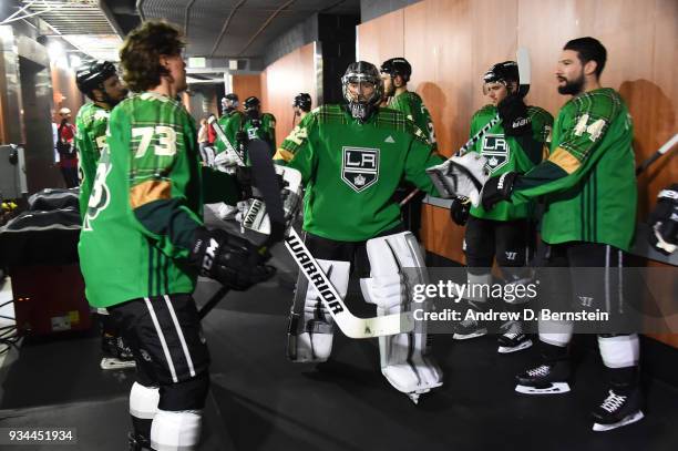 Jonathan Quick of the Los Angeles Kings high-fives Tyler Toffoli and Nate Thompson before a game against the New Jersey Devils at STAPLES Center on...