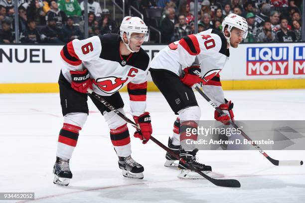 Andy Greene and Michael Grabner of the New Jersey Devils await a face-off during a game against the Los Angeles Kings at STAPLES Center on March 17,...