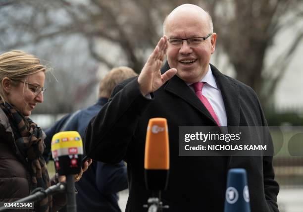 Newly named German Economy Minister Peter Altmaier waves after speaking to the press in front of the White House in Washington, DC, on March 19,...