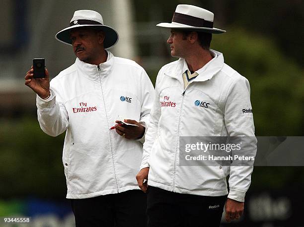 Umpires Billy Doctrove and Simon Taufel test the light during day four of the First Test match between New Zealand and Pakistan at University Oval on...