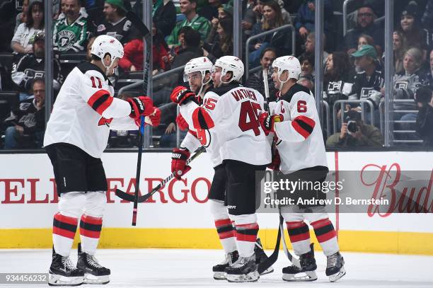 Brian Boyle, Sami Vatanen, Miles Wood, and Andy Greene of the New Jersey Devils celebrate after scoring a goal against the Los Angeles Kings at...