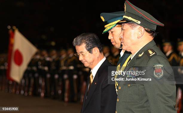 Chinese Defence Minister Liang Guanglie reviews a guard of honor with Japanese Defense Minister Toshimi Kitazawa at Defense Ministry on November 27,...