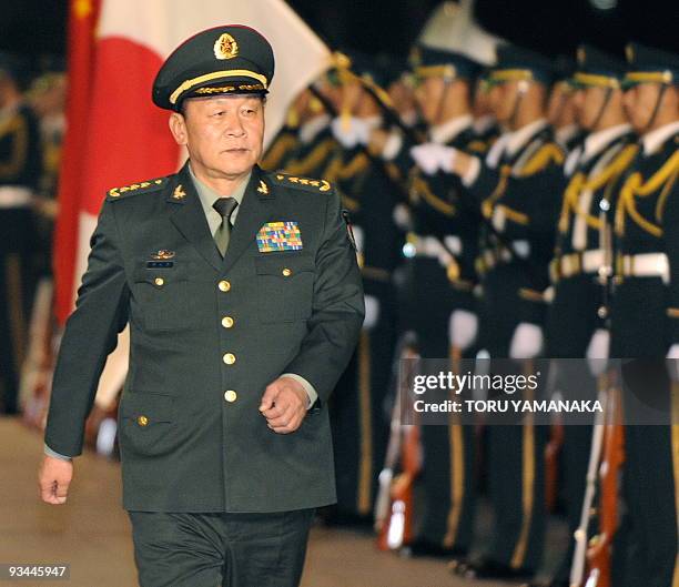 Chinese Defence Minister Liang Guanglie reviews an honor guard as he visits Japanese defence ministry to talk with his Japanese counterpart Toshimi...