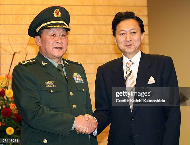 Chinese Defence Minister Liang Guanglie shakes hands with Japanese Prime Minister Yukio Hatoyama prior to their meeting at Hatoyama's official...