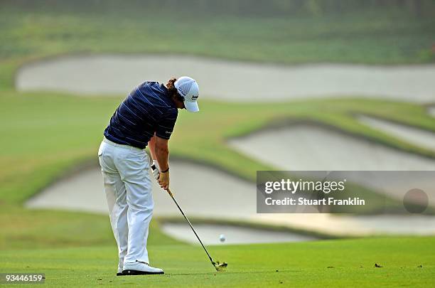 Rory McIlroy of Ireland plays his approach shot on the 14th hole during Foursomes on the second day of the Omega Mission Hills World Cup on the...