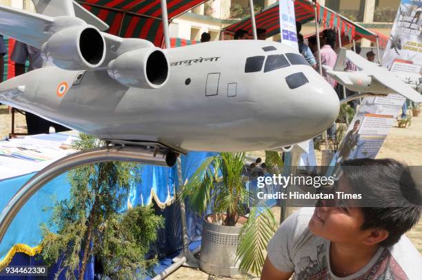 Kid looking at model of Indian Air Force plan during exhibition of Weapon and Equipment for public at under Headquarters Bengal Area at St. Xavier's...