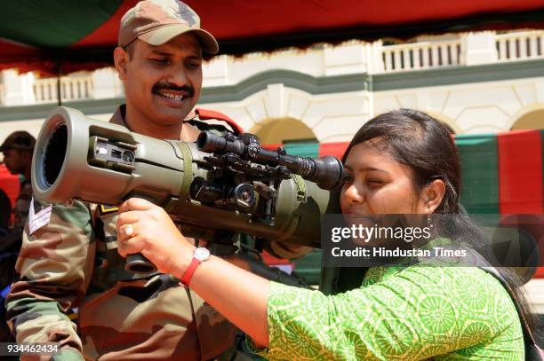 Girl checking rocket launcher during exhibition of Weapon and Equipment for public at under Headquarters Bengal Area at St. Xavier's College, Park...