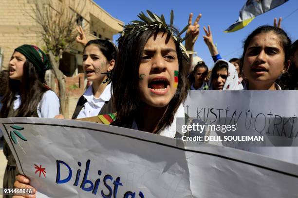 Syrian Kurds take part in a protest in the northeastern city of Amude, against the Turkish assault on Afrin, on March 19, 2018. Syria's foreign...