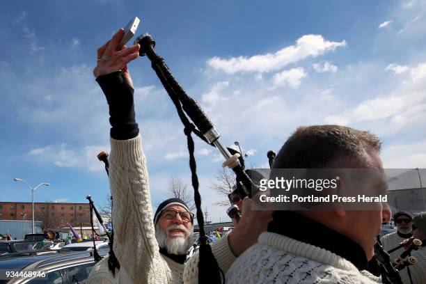 Jaff Cain, a member of the Claddagh Mohr Pipe Band checks the tuning of bagpipes on Saturday before the start of the annual St. Patrick's Day.