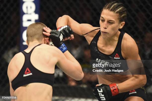 Joanna Jedrzejczyk of Poland punches Rose Namajunas in their UFC women's strawweight championship bout during the UFC 217 event inside Madison Square...