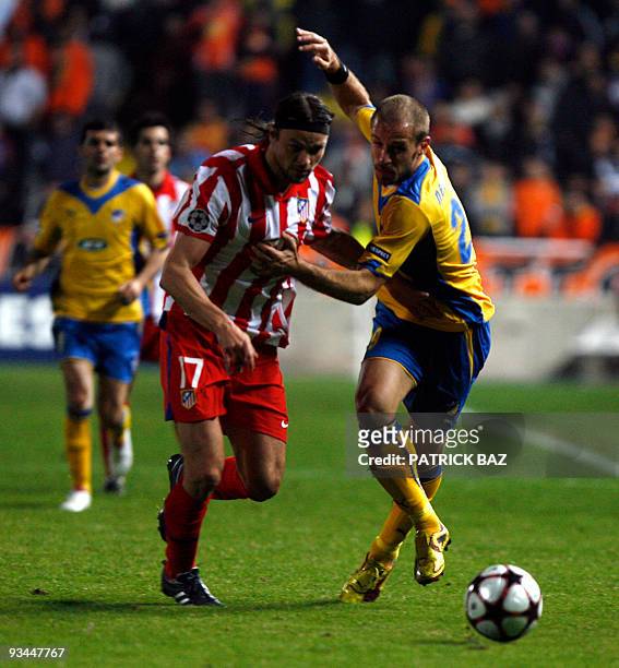 Apoel Nicosia's Nectarios Alexandrou vies with Atletico Madrid's Tomas Ujfalusi during their UEFA Champions League group D football match at the GSP...