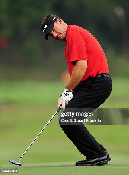 Alex Cejka of Germany reacst to his putt on the 11th hole during Foursomes on the second day of the Omega Mission Hills World Cup on the Olazabal...