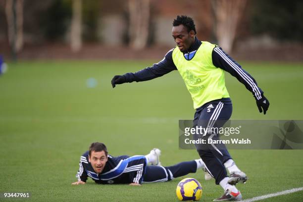 Michael Essien and Joe Cole of Chelsea in action during a training session at Chelsea Training Ground on November 27, 2009 in Cobham, England.