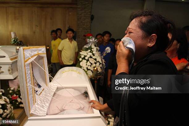 Relative of a journalist who was among the 57 people massacred in the southern Philippine town of Ampatuan in Maguindanao this week, weeps at a wake...