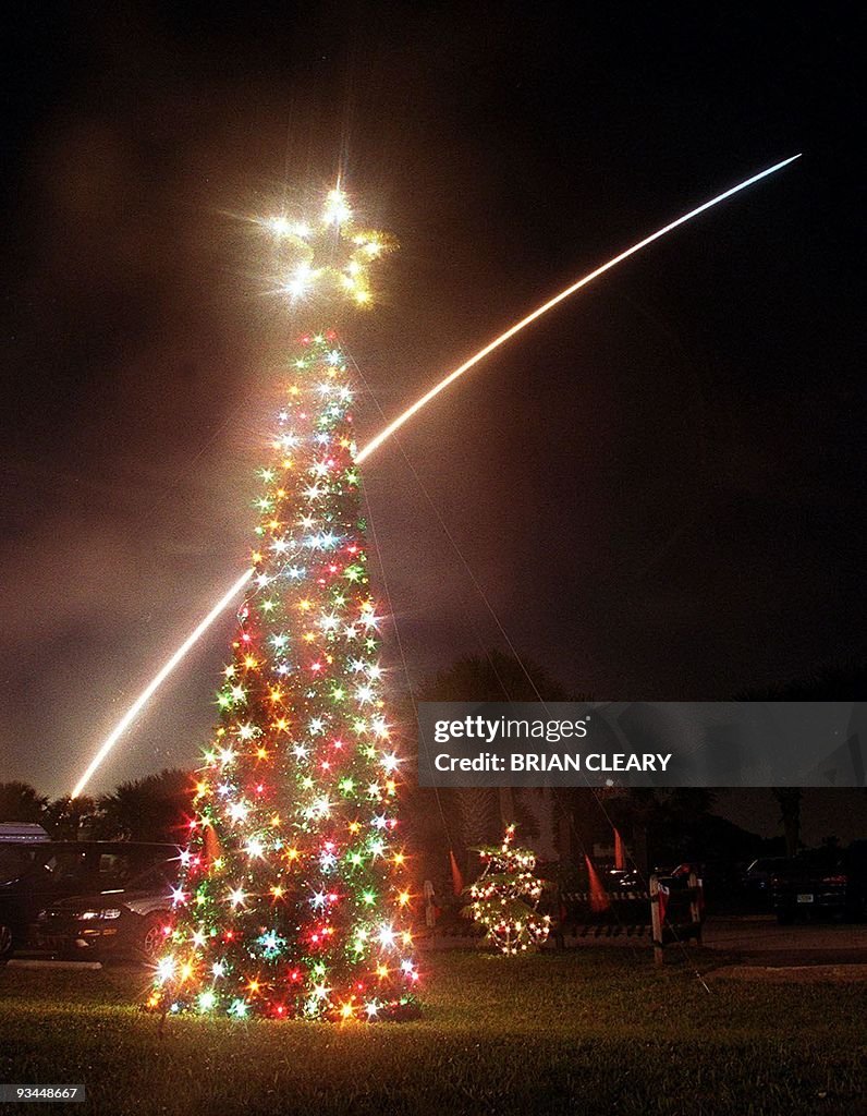 The space shuttle Discovery streaks into