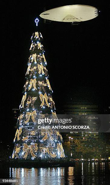 The Pax Rio dirigible, used by the military police to patrol the city, flies during the inauguration of the 82-meter tall Christmas Tree 30 November...