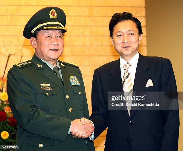 Chinese Defence Minister Liang Guanglie shakes hands with Japanese Prime Minister Yukio Hatoyama prior to their meeting at Hatoyama's official...