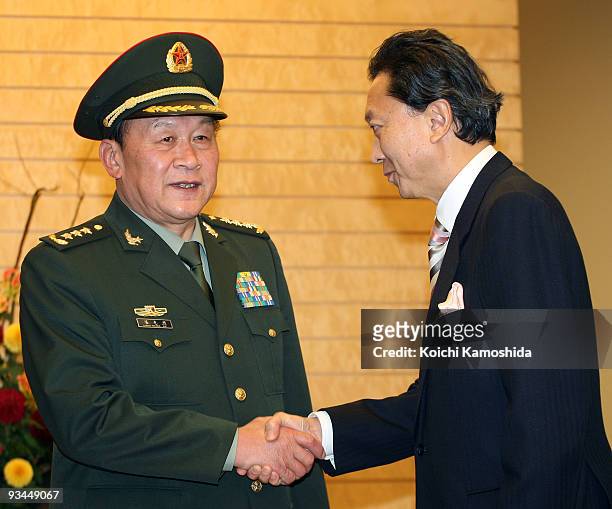 Chinese Defence Minister Liang Guanglie shakes hands with Japanese Prime Minister Yukio Hatoyama prior to their meeting at Hatoyama's official...