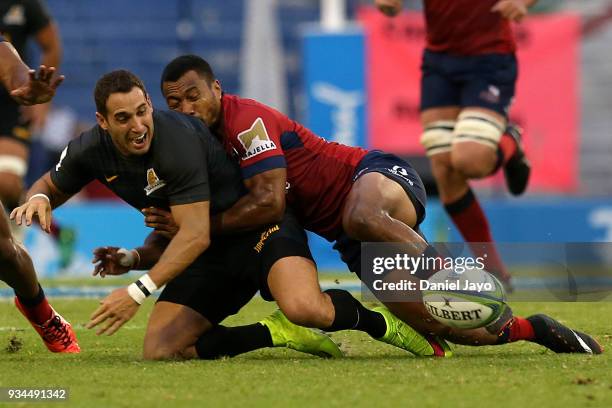 Joaquín Tuculet of Jaguares is tackled by Aidan Toua of Reds during a match between Jaguares and Reds as part of the fifth round of Super Rugby at...