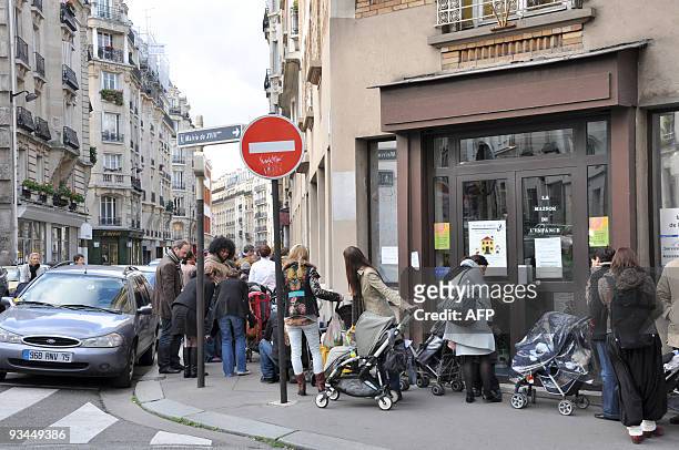 People queue with their children to be vaccinated against swine flu on November 27, 2009 in Paris. France's Health minister told today that children...