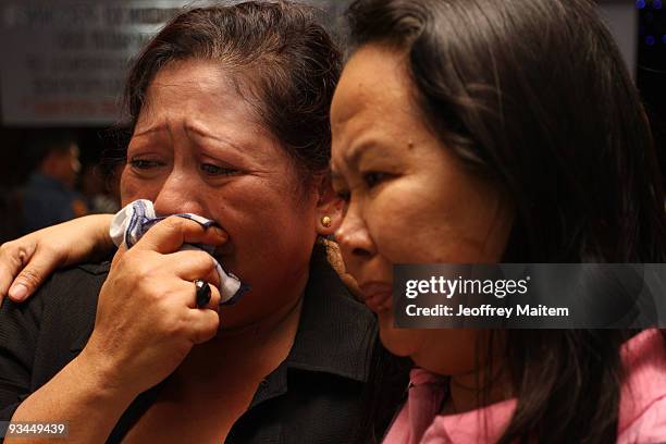 Relatives of a journalist, one of 57 people massacred in the southern Philippine town of Ampatuan in Maguindanao, weep at a wake held for the...