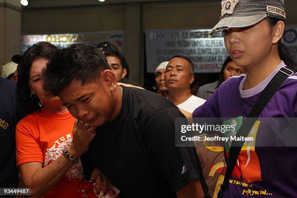Son of journalist Maritess Cablitas among those 57 people massacred in the southern Philippine town of Ampatuan in Maguindanao this week weeps at a...