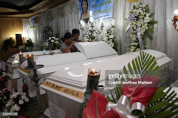 Relatives, friends and supporters of journalists among 57 people massacred in the southern Philippine town of Ampatuan in Maguindanao are seen at a...