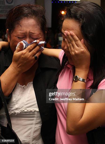 Relatives of a journalist, one of 57 people massacred in the southern Philippine town of Ampatuan in Maguindanao, weep at a wake held for the...