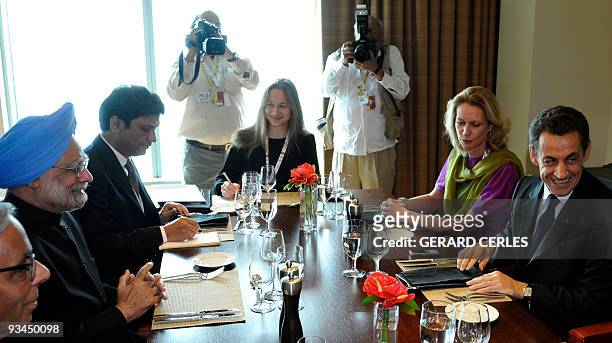 French President Nicolas Sarkozy jokes with Indian President Mammohan Singh prior to a working lunch on the sideline of the Commonwealth Climate...