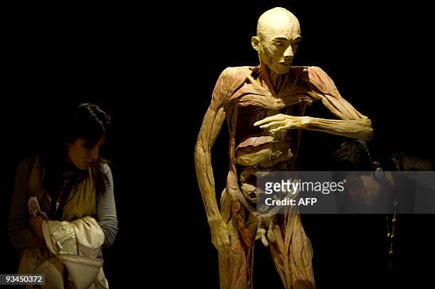 Visitors look at a body on display at the "Bodies...The Exhibition" at the Exhibition and Congress Palace in Granada, southern Spain, on November 27,...