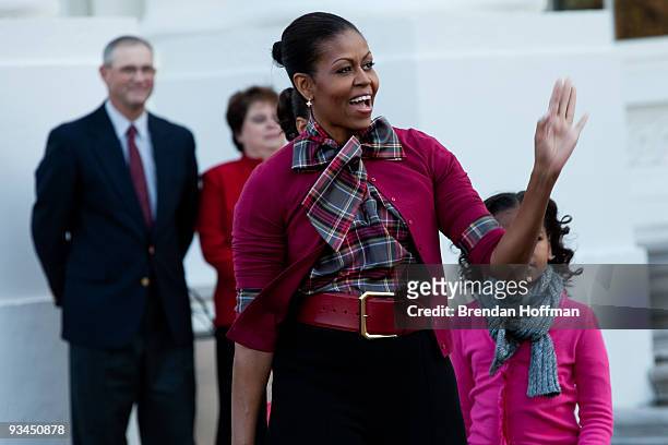 First lady Michelle Obama welcomes the White House Christmas Tree at the North Portico of the White House on November 27, 2009 in Washington, DC. The...