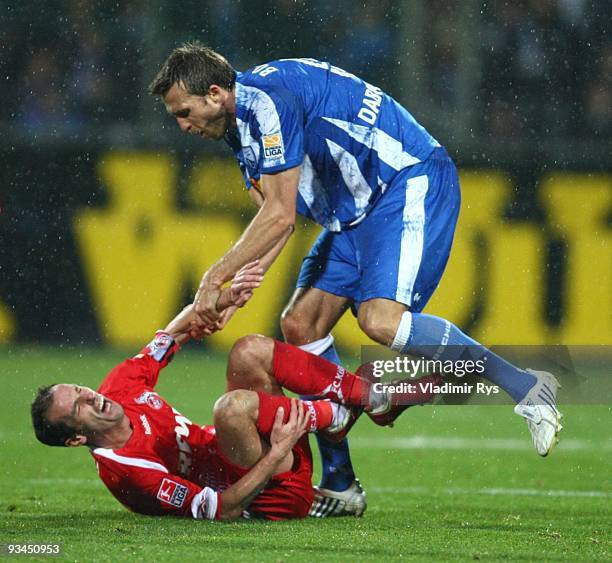 Christoph Dabrowski of VfL Bochum tries to pull Armando Petit of FC Koeln to his feet after he fouled him during the Bundesliga match between VfL...