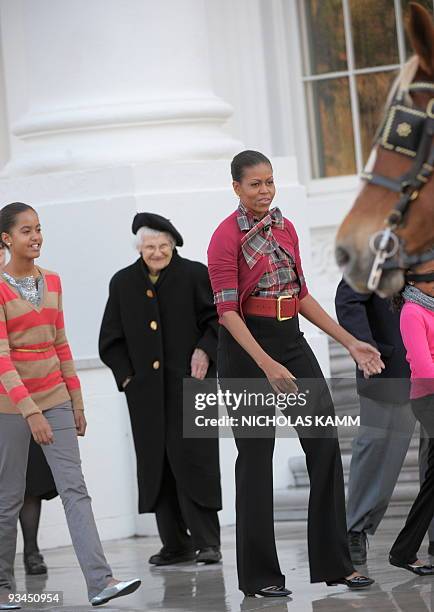 First Lady Michelle Obama arrives with her daughter Malia to receive the official White House Christmas Tree at the North Portico of the White House...