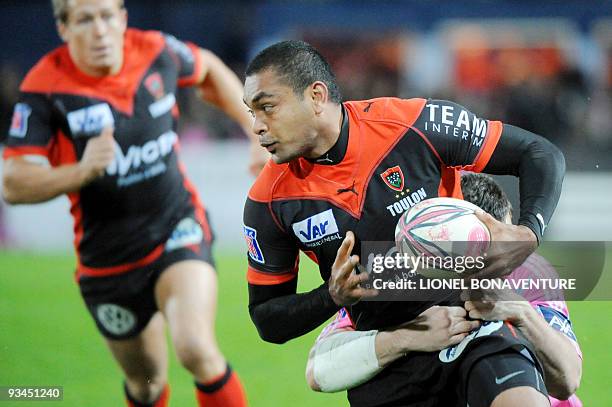 Paris' prop Laurent Sempere vies with Toulon's center Mafileo Kefu as toulon's fly half Johnny Wilkinson , during the French Top 14 Rugby Union match...