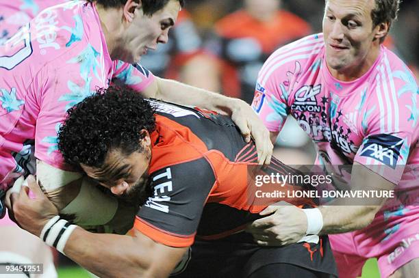 Paris' players Fabien Cibray and center Mark Gasnier fight for the ball with Toulon winger Christian Loamanu during the French Top 14 Rugby Union...