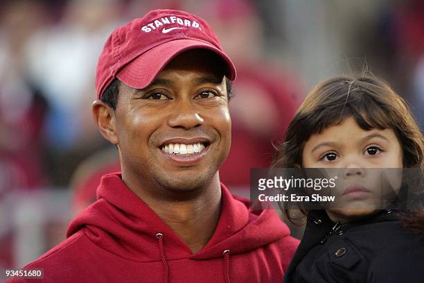 Honorary Standford Cardinal captain Tiger Woods holds his daugher, Sam, on the sidelines before the Cardinal game against the California Bears at...