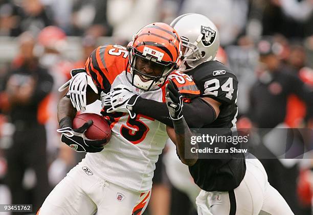 Chad Ochocinco of the Cincinnati Bengals is tackled by Michael Huff of the Oakland Raiders at Oakland-Alameda County Coliseum on November 22, 2009 in...