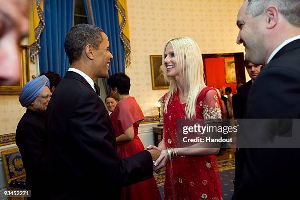 In this handout image provided by The White House, President Barack Obama greets Michaele Salahi and Tareq Salahi at a State Dinner in the State...