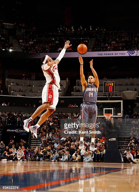 LeBron James of the Cleveland Cavaliers tries to block a shot by D.J. Augustin of the Charlotte Bobcats on November 27, 2009 at the Time Warner Cable...