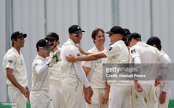 Peter Fulton and Shane Bond of New Zealand celebrate the wicket of Fawad Alam of Pakistan during day five of the First Test match between New Zealand...