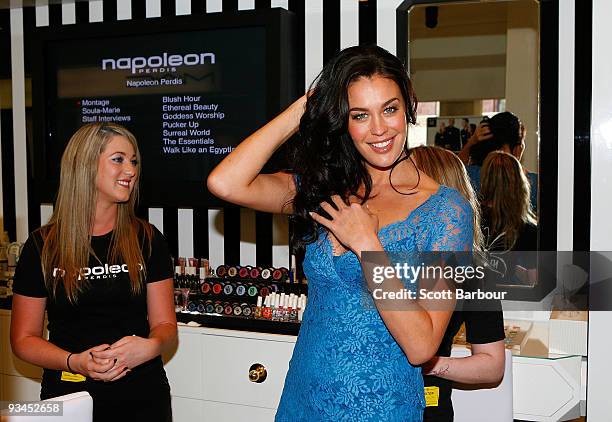 Model Megan Gale visits the cosmetics department as she tours the store during the official opening of stage one of the David Jones Bourke Street...