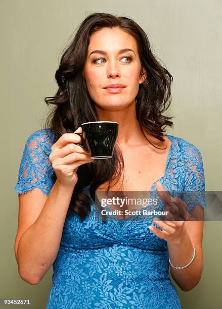 Model Megan Gale drinks a cup of coffee as she attends the official opening of stage one of the David Jones Bourke Street Mall redevelopment on...
