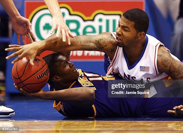 Markieff Morris of the Kansas Jayhawks battles Terrell Barnes of the Tennessee Tech Golden Eagles for a loose ball during the game on November 27,...