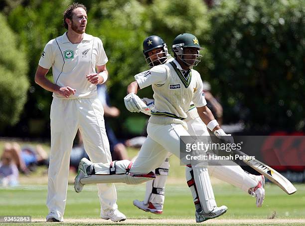 Iain O'Brien of New Zealand looks on as Mohammad Yousuf and Umar Akmal run between the wickets during day five of the First Test match between New...